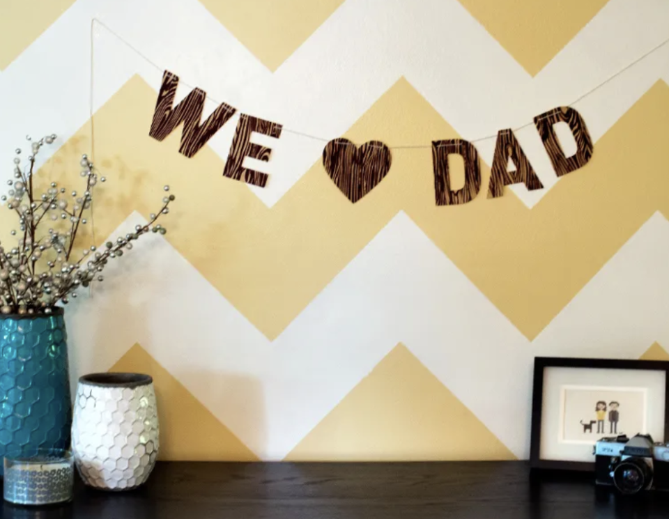 father's day crafts we love dad banner hanging on the white and yellow patterned wall