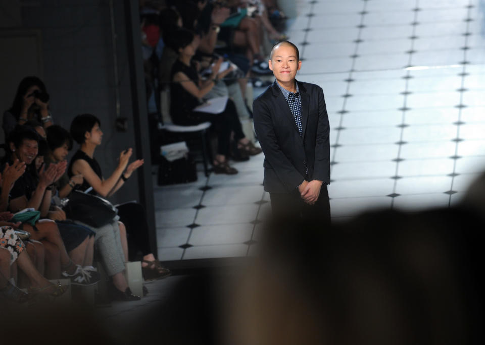 Designer Jason Wu greets the crowd after showing the Jason Wu spring 2013 collection, Friday, Sept. 7, 2012 in New York. (Photo by Diane Bondareff/Invision/AP)