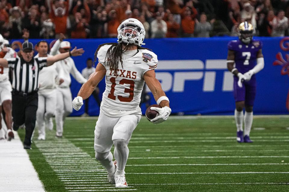 Texas Longhorns wide receiver Jordan Whittington (13) celebrates a catch for a first down during the Sugar Bowl College Football Playoff semifinals game against the Washington Huskies at the Caesars Superdome on Monday, Jan. 1, 2024 in New Orleans, Louisiana.