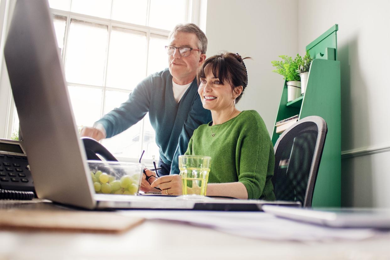 Two mature adults working at home