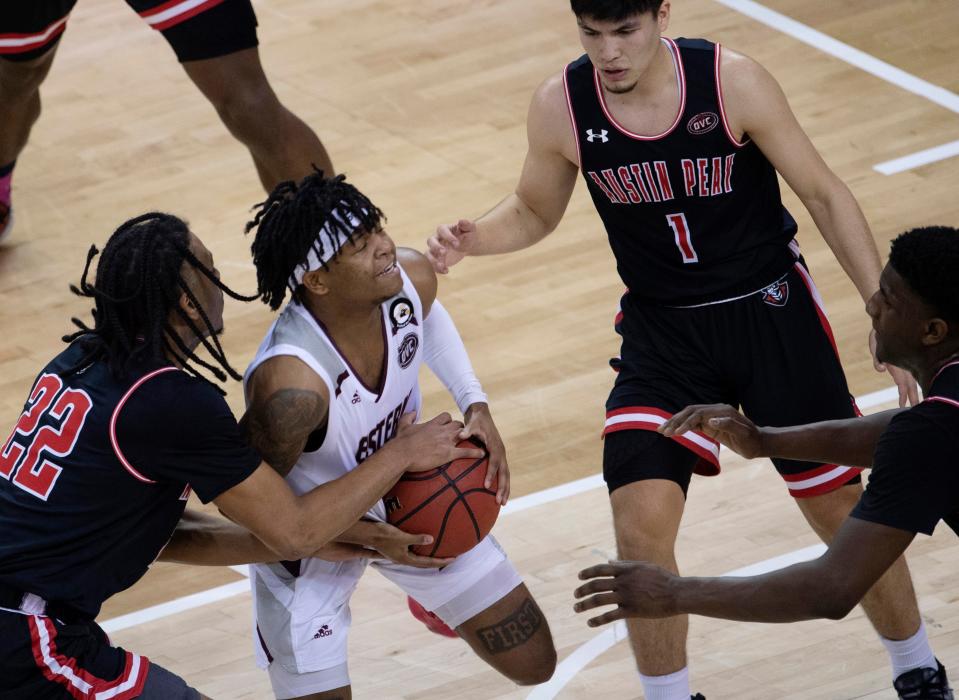 Austin Peay's Alec Woodard (22) gets the held ball call against Eastern Kentucky's Wendell Green (12) during their quarterfinal game of the Ohio Valley Conference 2021 Basketball Championships at the Ford Center in Evansville, Ind., Thursday night, March 4, 2021.