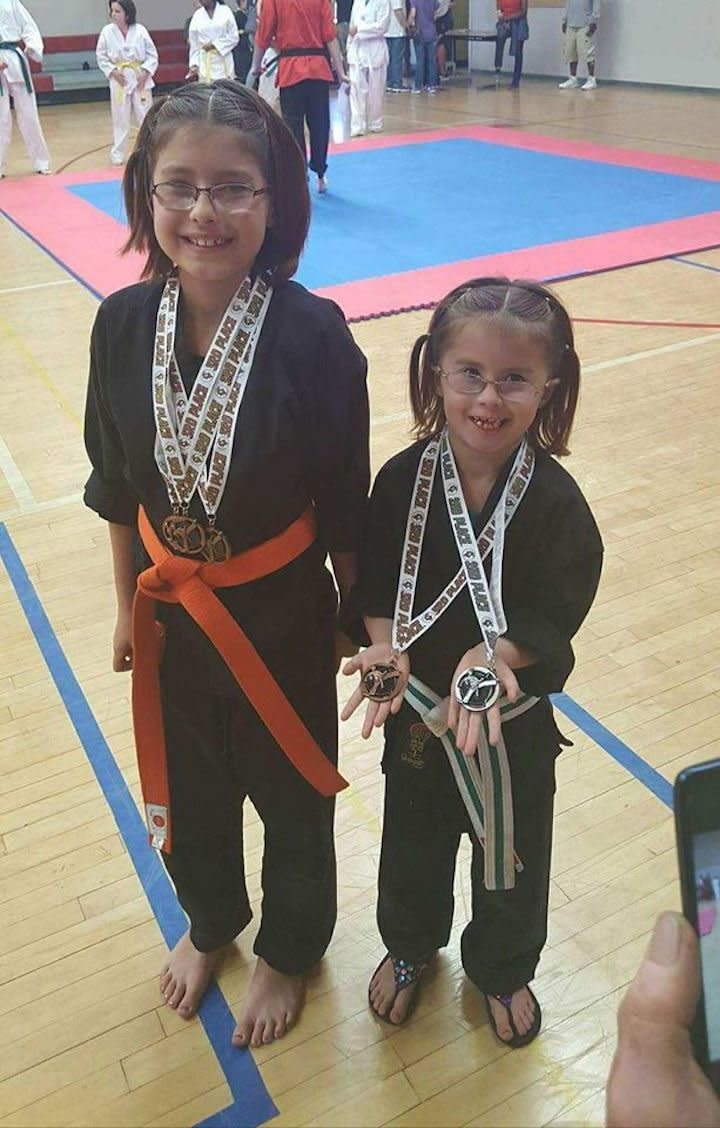 "My strong girls at their last karate tournament. My youngest leads her class and my oldest helps teach weapons. So proud of them!"