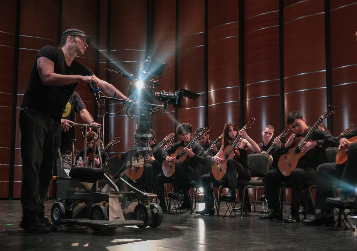 Robert Rodriguez films an Austin Classical Guitar student orchestra as they play a medley of his "Spy Kids" music at the Long Center for the Performing Arts. Rodriguez has donated rights to his music for ACG's digital teaching platform, which is used around the world.