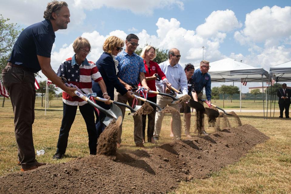 Members of the Veterans Land Board and public officials shovel dirt during a ground breaking ceremony for an expansion of the Coastal Bend State Veterans Cemetery on Friday, Sept. 22, 2023, in Corpus Christi, Texas.