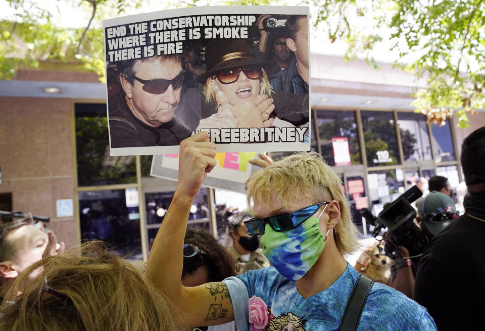 Britney Spears supporter Biblegirl holds a sign outside a court hearing concerning the pop singer's conservatorship at the Stanley Mosk Courthouse, Wednesday, June 23, 2021, in Los Angeles. (AP Photo/Chris Pizzello)