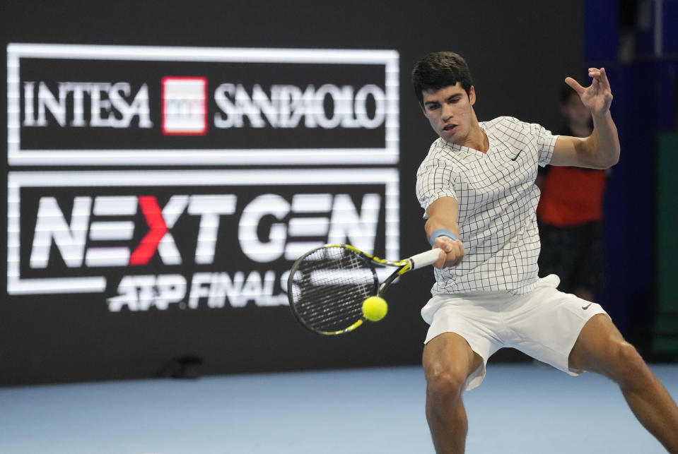 FILE - Spain's Carlos Alcaraz returns the ball to Argentina's Sebastian Baez during an ATP Next Gen semifinal tennis match in Milan, Italy, Friday, Nov. 12, 2021. Saudi Arabia's Public Investment Fund and the men's professional tennis tour announced a multiyear partnership on Wednesday, Feb. 28, 2024, that includes naming rights for the ATP rankings, the latest move into sports by the kingdom.(AP Photo/Antonio Calanni, File)