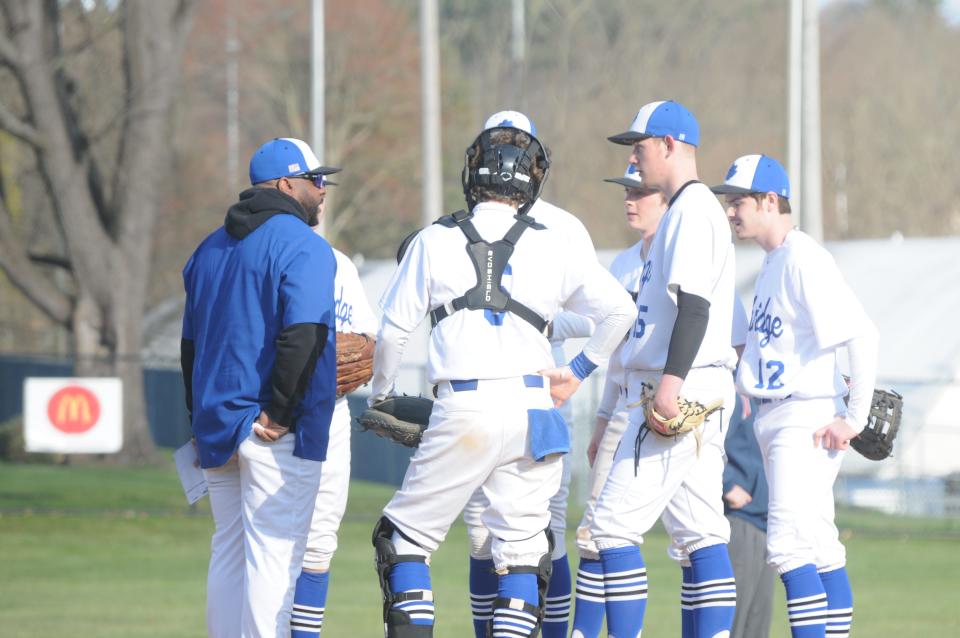 Cambridge head coach Jamaal Lowery meets with his players on the mound during the Bobcats season opener with St. Clairsville. The Bobcats have started the new season off with a 1-1 record in the early going.