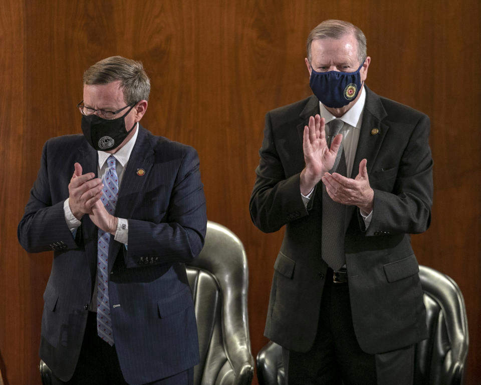 House Speaker Tim Moore, left, and Sen. Phil Berger applaud North Carolina Gov. Roy Cooper after Cooper delivered his State of the State address before a joint session of the North Carolina House and Senate, Monday, April 26, 2021, in Raleigh, N.C. (Robert Willett/The News & Observer via AP)