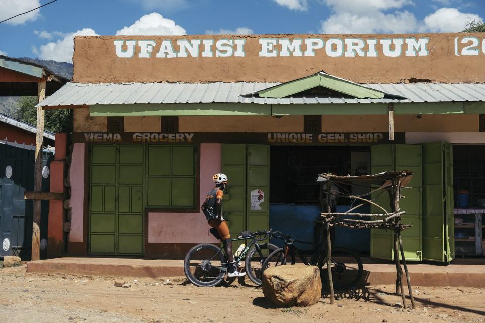geoffrey langat waits outside a shop with his bike on a training ride near iten kenya