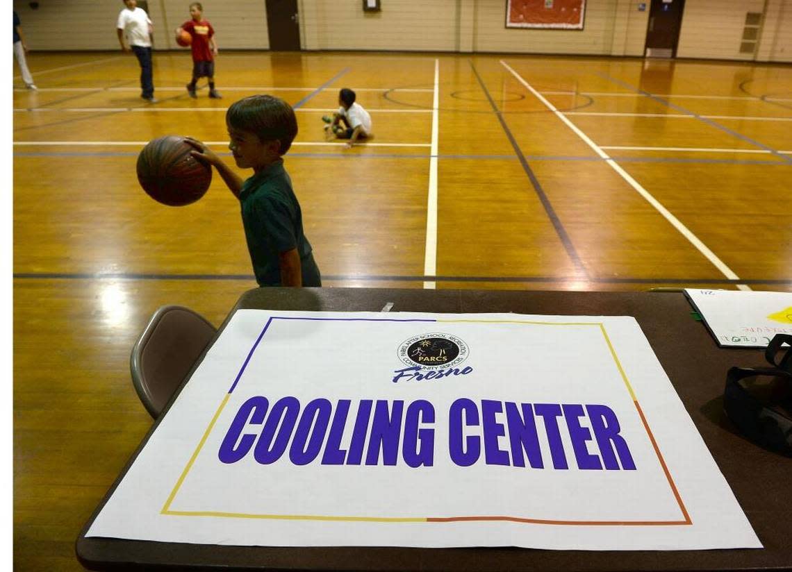 Kids play basketball at Ted C. Wills Community Center, one the four cooling centers in the city of Fresno. MARK CROSSE/Fresno Bee file