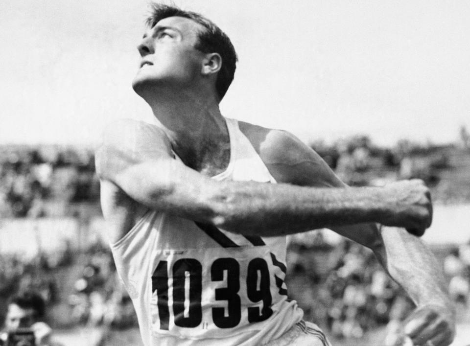 FILE - In this July 26, 1952, file photo, Bob Mathias, defending Olympic decathlon champion, heaves the discus during the decathlon competition at the Summer Olympic games in Helsinki, Finland. (AP Photo/File)