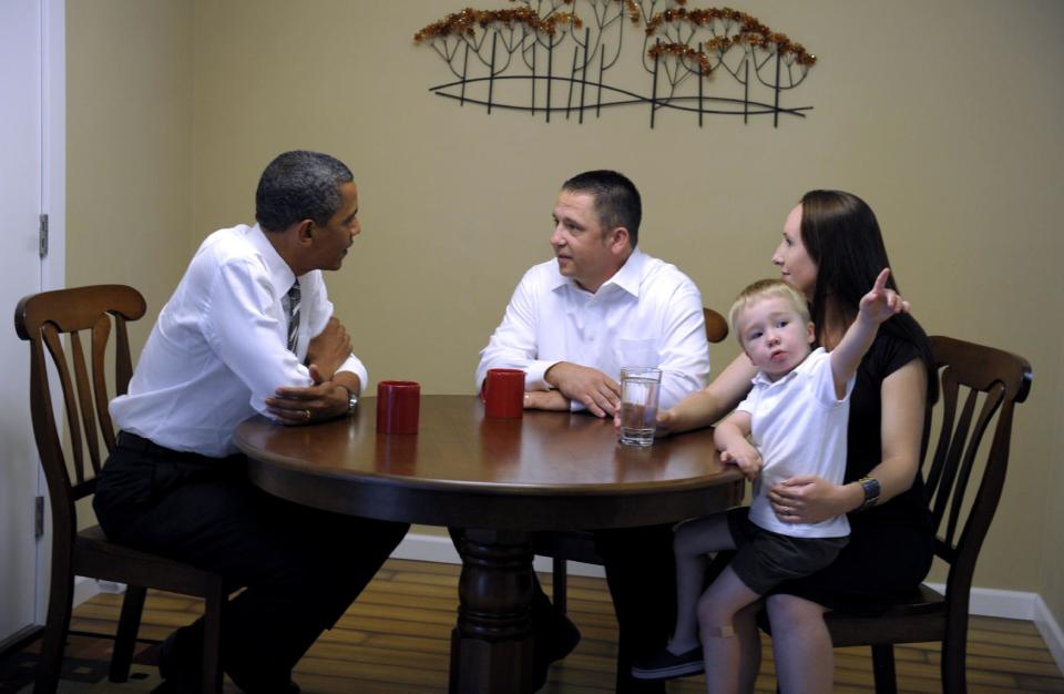 President Barack Obama talks with Jason and Ali McLaughlin and their son Cooper while visiting their home in Cedar Rapids, Iowa, Tuesday, July 10, 2012. (AP Photo/Susan Walsh)