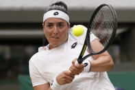 Tunisia's Ons Jabeur returns the ball to Belgium's Elise Mertens during a fourth round women's singles match on day seven of the Wimbledon tennis championships in London, Sunday, July 3, 2022. (AP Photo/Alberto Pezzali)