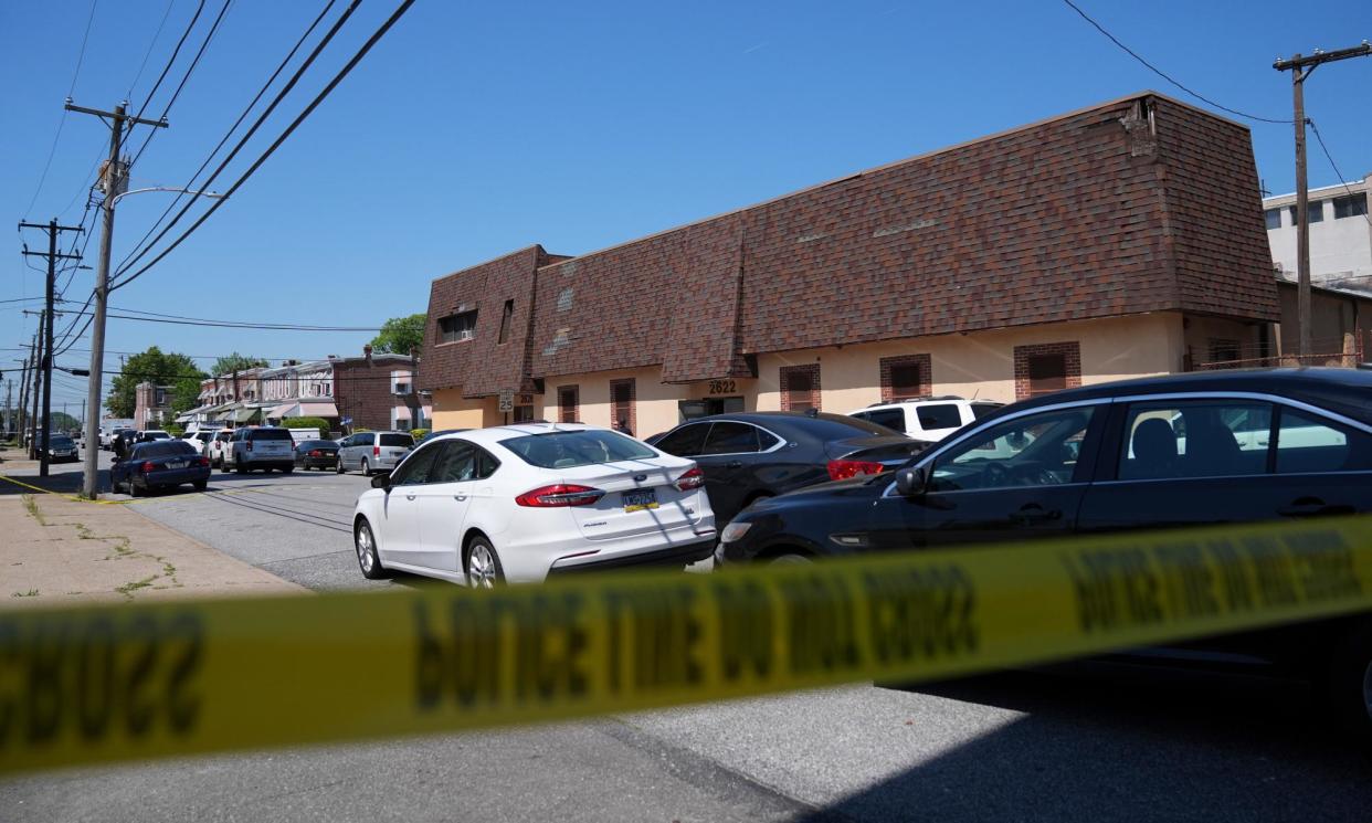 <span>Police tape cordons off the scene of a fatal shooting at Delaware County Linen in Chester, Pennsylvania.</span><span>Photograph: Matt Rourke/AP</span>