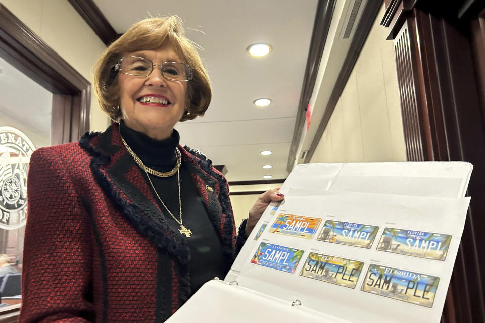 Florida Republican Sen. Gayle Harrell shows samples of a proposed specialty license plate to honor iconic Florida singer Jimmy Buffet, Wednesday, Jan. 10, 2024, in Tallahassee, Fla. (AP Photo/Brendan Farrington, File)