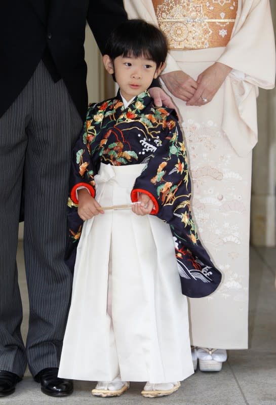 FILE PHOTO: Japan's Prince Hisahito, son of Prince Akishino and Princess Kiko, is accompanied by his parents after the Chakko-no-Gi and Fukasogi-no-gi ceremonies in Tokyo