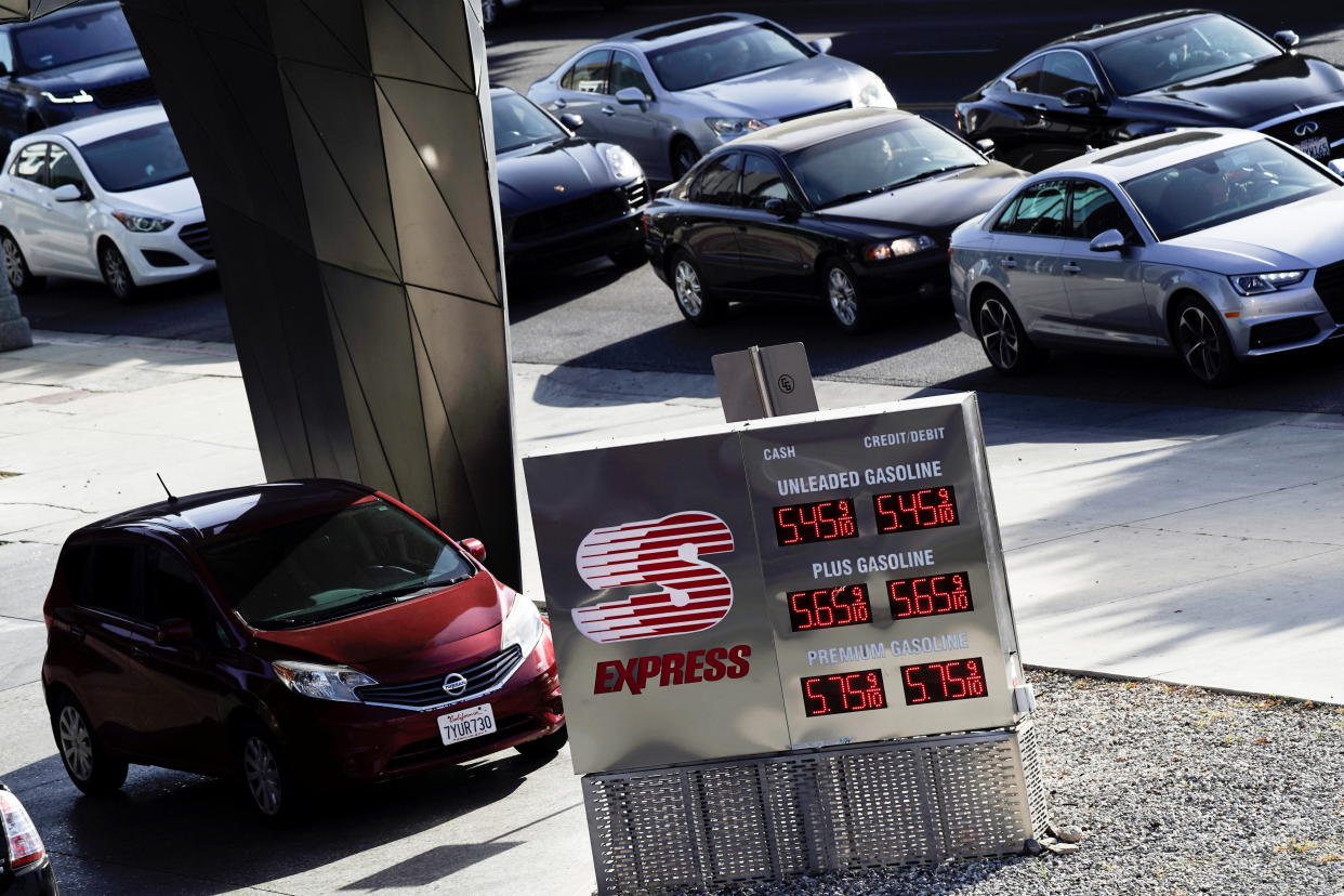 A vehicle is parked next to a sign displaying Speedway gasoline prices at the Helios House, the first LEED-certified gas station in the United States, as cars wait in traffic in West Olympic Boulevard in Los Angeles, California, U.S., March 10, 2022. Picture taken March 10, 2022. REUTERS/Bing Guan
