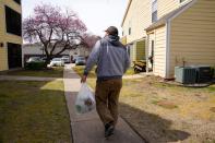 Chlebanowski looks for a customer's apartment to deliver produce in Norman