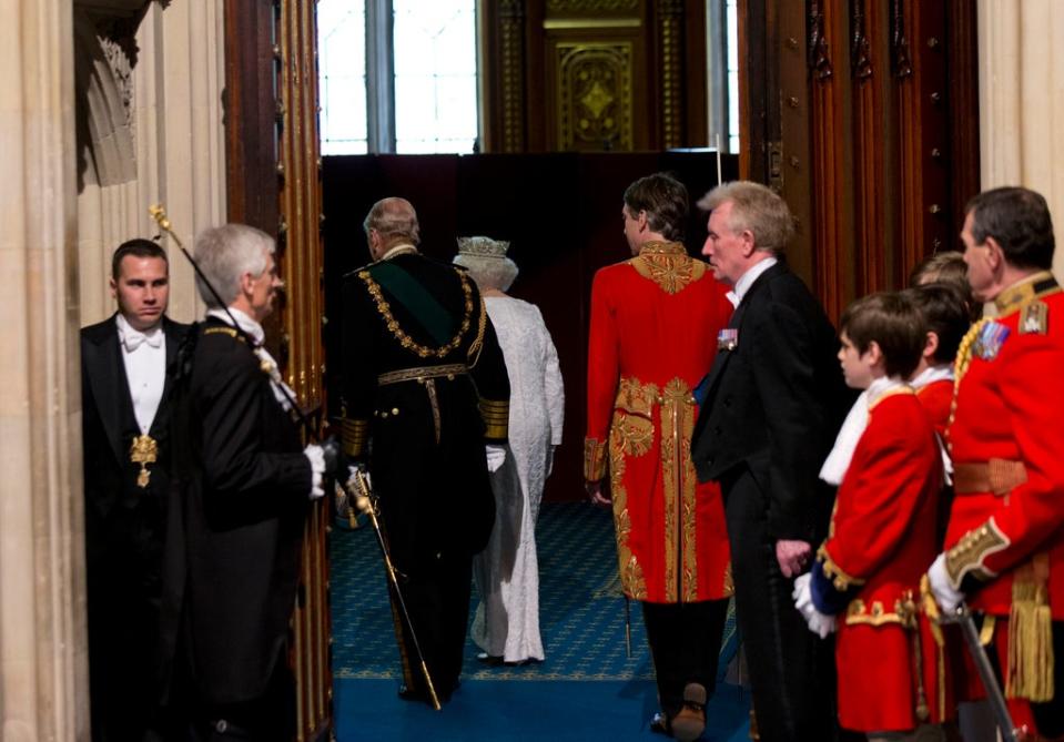 The Queen and the Duke of Edinburgh walk through to the Robing Room, after using a lift, rather than stairs, at the State Opening of Parliament (Yui Mok/PA)