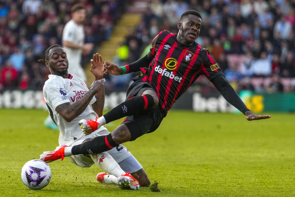 Manchester United's Aaron Wan-Bissaka, left, duels for the ball with Bournemouth's Dango Ouattara during the English Premier League soccer match between Bournemouth and Manchester United, at The Vitality Stadium in Bournemouth, England, Saturday, April 13, 2024. (AP Photo/Kirsty Wigglesworth)
