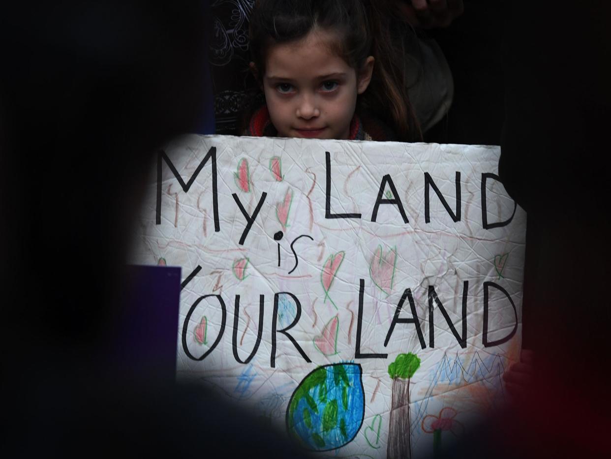 Maya Casillas, 7, joins migrant rights group during a vigil to protest against US President Donald Trump's new crackdown on 'sanctuary cities', outside the City Hall in Los Angeles: MARK RALSTON/AFP/Getty Images