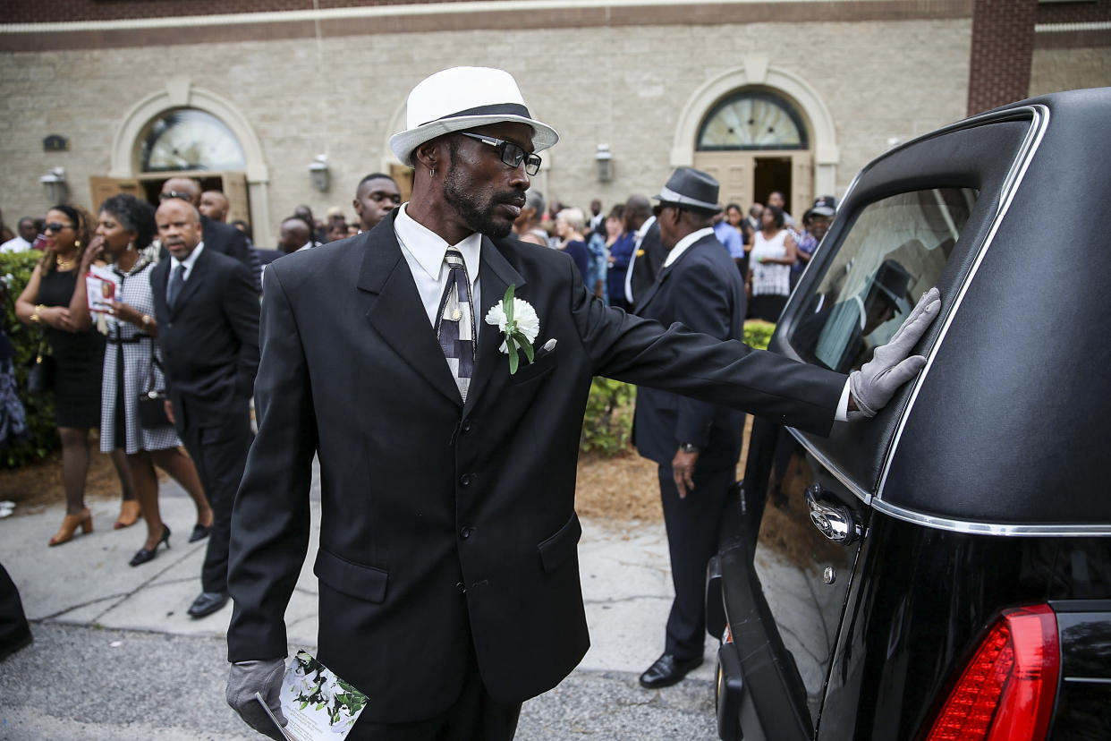 Image: A mourner touches the back of the hearse carrying the casket of Ethel Lance, 70, who was one of nine victims of a mass shooting at the Emanuel African Methodist Episcopal Church, on June 25, 2015 in North Charleston, S.C. (Joe Raedle / Getty Images file)