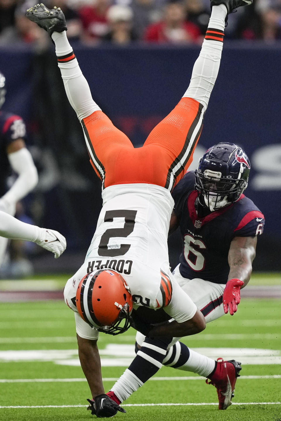 Cleveland Browns wide receiver Amari Cooper (2) catches a pass as Houston Texans linebacker Denzel Perryman (6) defends during the second half of an NFL football game Sunday, Dec. 24, 2023, in Houston. (AP Photo/David J. Phillip)