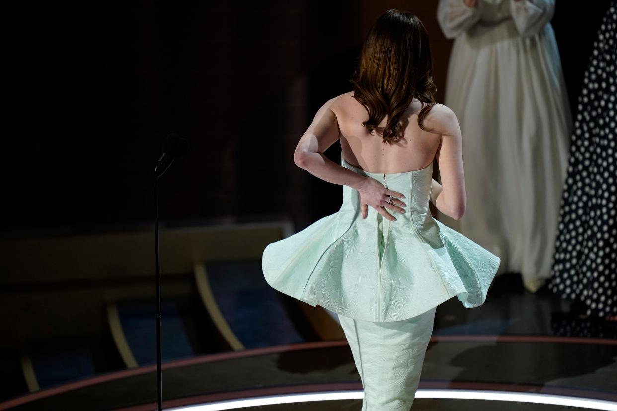 Emma Stone holds her dress as she walks of stage after accepting the award for best actress in a leading role for her role in "Poor Things" during the 96th Oscars at the Dolby Theatre at Ovation Hollywood in Los Angeles on Sunday, March 10, 2024.