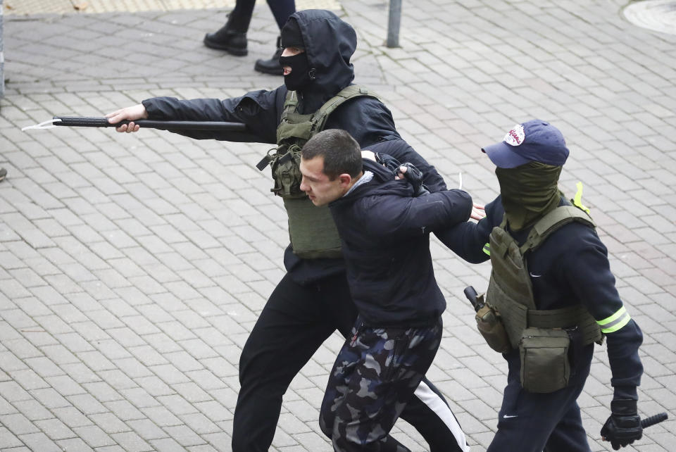 Police detain a man during an opposition rally to protest the official presidential election results in Minsk, Belarus, Sunday, Nov. 8, 2020. Club-swinging police went after demonstrators in the Belarusian capital who were demanding the resignation of the country's authoritarian president on Sunday, the 90th consecutive day of protests in the country. Human rights activists said nearly 400 people were arrested. (AP Photo)