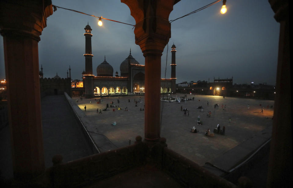 Muslims offer prayers and break fast on the first day of the holy month of Ramadan at the Jama Mosque, in New Delhi, India, Wednesday, April 14, 2021. Due to the COVID-19 situation only a handful of people turned up. Muslims across the world are observing the holy fasting month of Ramadan, where they refrain from eating, drinking and smoking from dawn to dusk. (AP Photo/Manish Swarup)