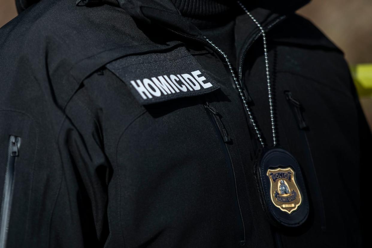 A man in an Integrated Homicide Investigation Team (IHIT) uniform is pictured. (Ben Nelms/CBC - image credit)