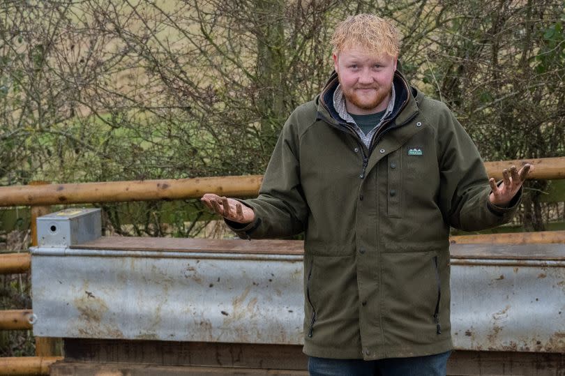 Kaleb Cooper
Clarksons Farm
AMAZON 
muddy farm with hands up in jokey despondent pose, wearing wellies