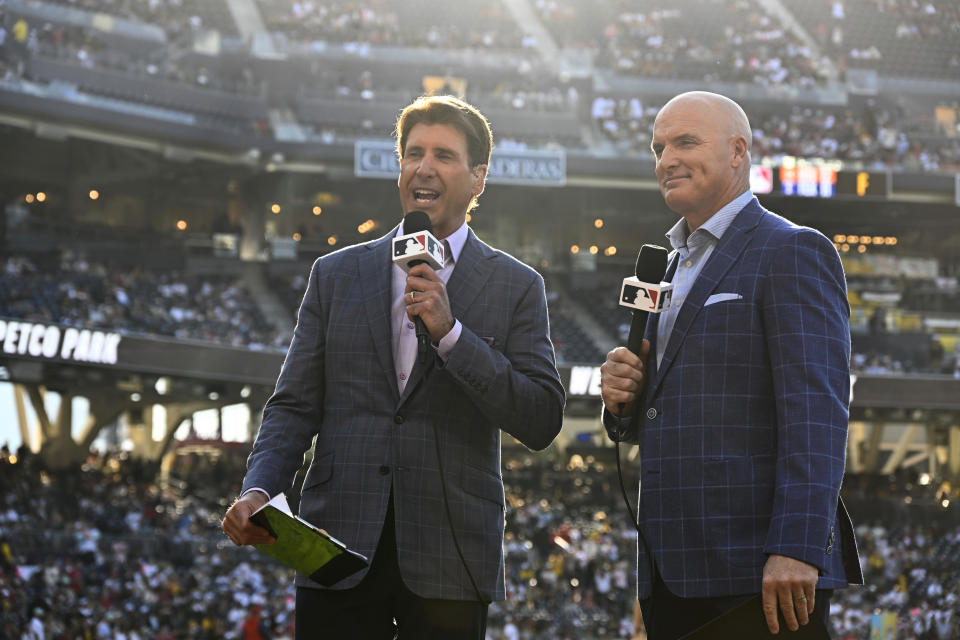 MLB broadcasters Mike Pomeranz, left, and Mark Sweeney speak before a baseball game between the Los Angeles Angels and the San Diego Padres on Monday, July 3, 2023, in San Diego. MLB's takeover of San Diego Padres' broadcasts involved months of planning, a playbook MLB is following this week with Arizona Diamondbacks' telecasts. (AP Photo/Denis Poroy)