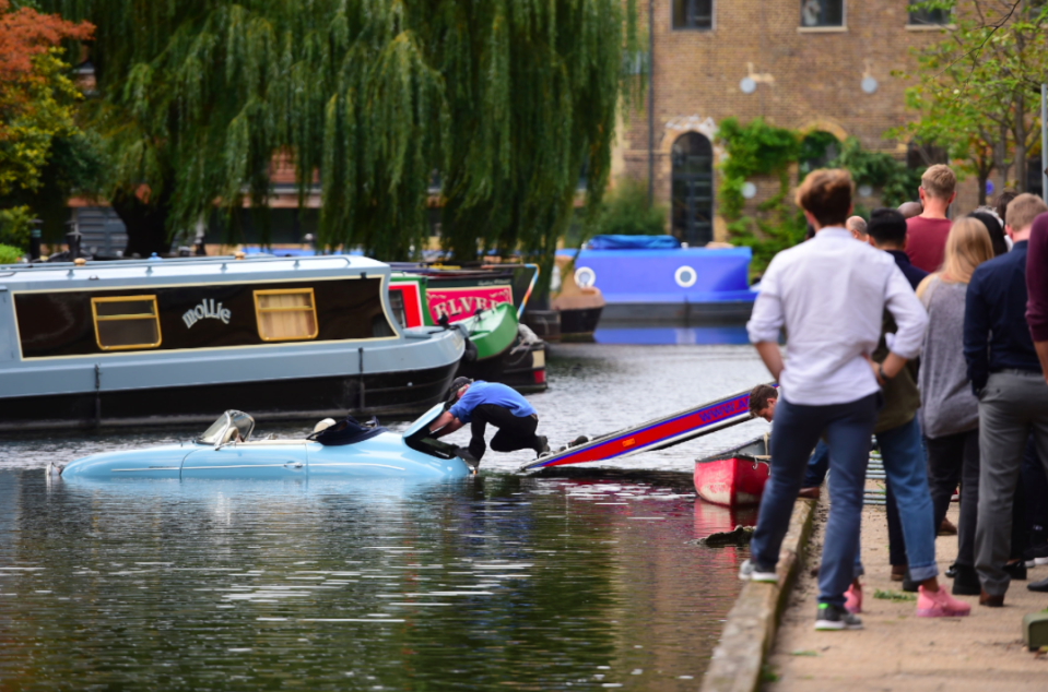 <em>Crowds gathered to watch the two-seater soft top be pulled from Wenlock Basin (PA)</em>