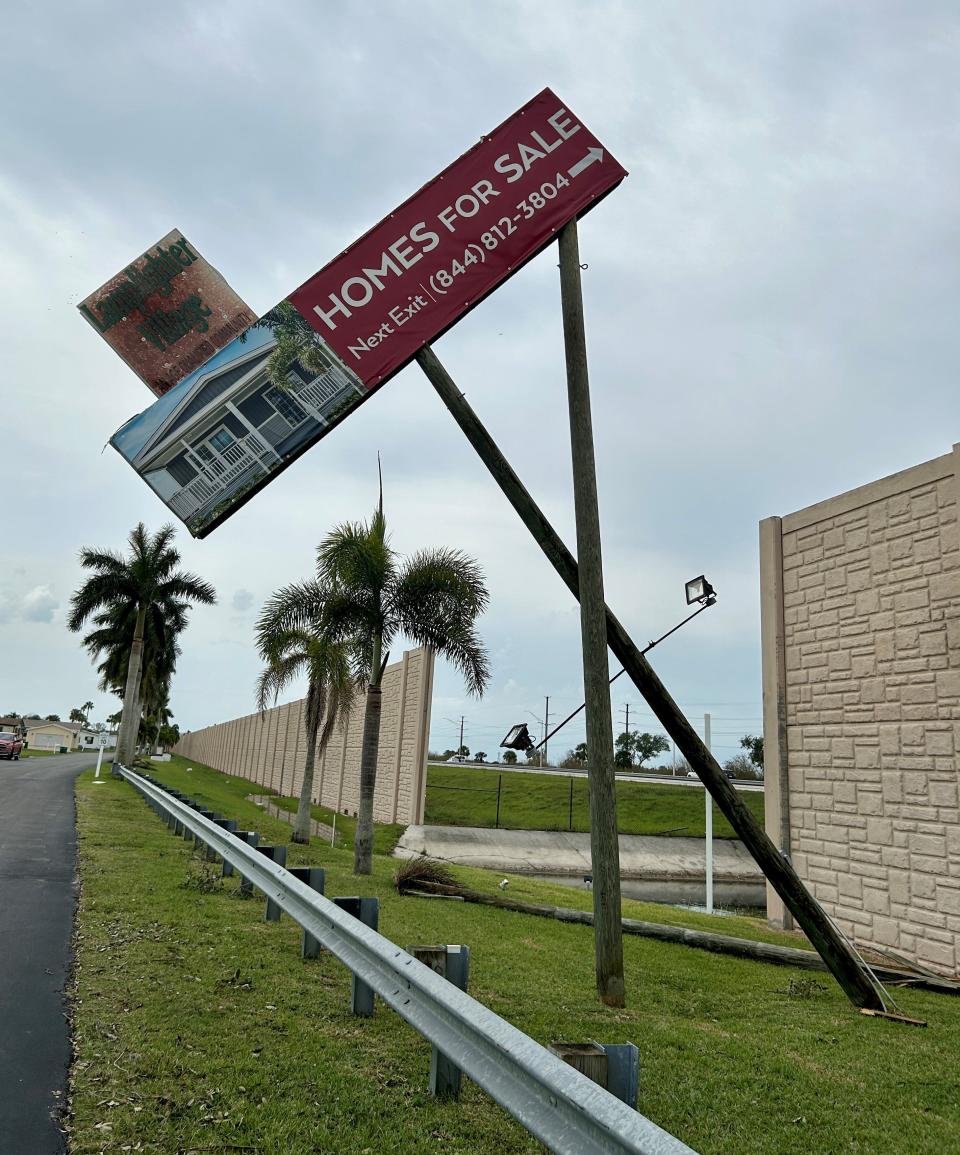 A wooden pole for a Lamplighter Village sign facing Interstate 95 traffic remains snapped off at its base after Wednesday's powerful storms struck the West Melbourne area.