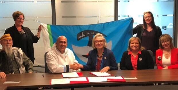 NCC president Todd Russell, second from left, signed a memorandum of understanding in September 2019. (Nunatukavut.ca - image credit)