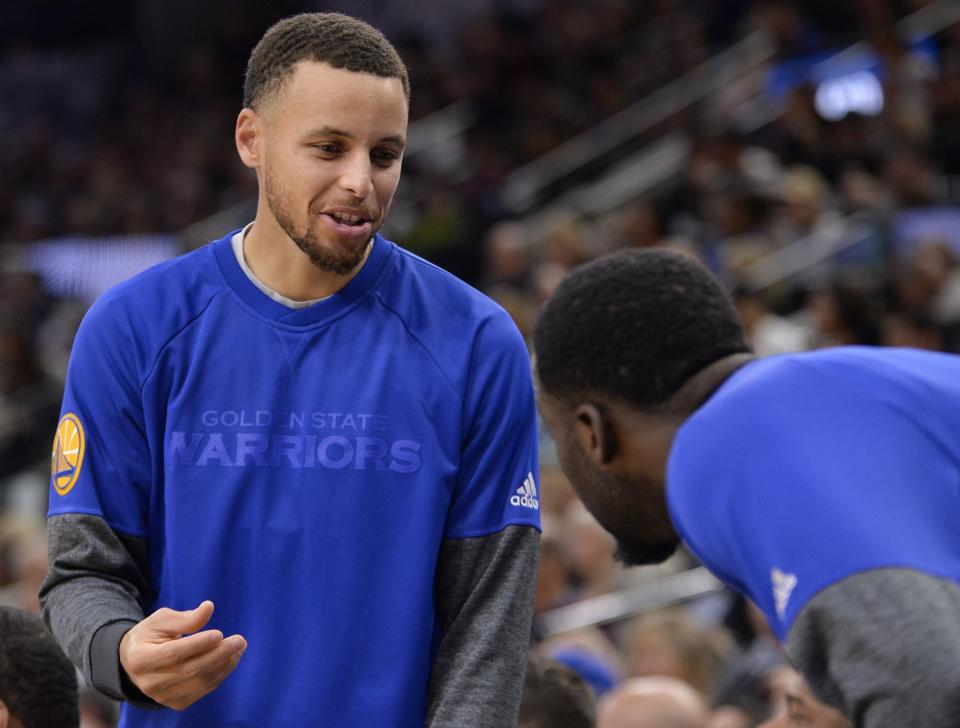 Steph Curry and Draymond Green didn’t have to remove their warmups Saturday night. (AP)