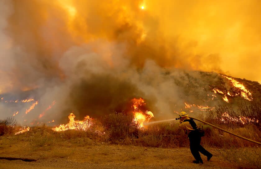 HEMET, CALIF. - SEP 6, 2022. A firefighter battles the Fairview fire along Batista Road near Hemet on Tuesday, Sep. 6, 2022. (Luis Sinco / Los Angeles Times)