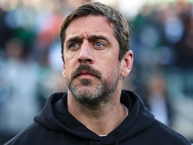 <p>Perry Knotts/Getty</p> Aaron Rodgers during the national anthem prior to an NFL football game against the Miami Dolphins at MetLife Stadium on November 24, 2023 in East Rutherford, New Jersey.