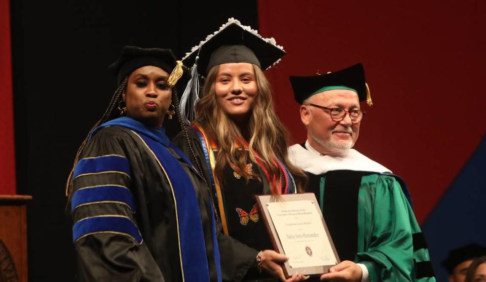 Daisy Soto-Hernández, who graduated as the dean’s undergraduate medalist from the Fresno State Kremen School of Education, was recognized by associate dean Janelle Pitt Parker and dean Randy Yerrik at the May 19, 2023 commencement at the Save Mart Center.