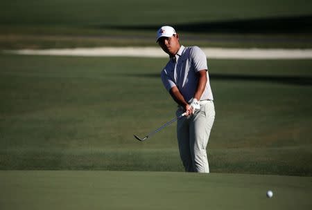 May 14, 2017; Ponte Vedra Beach, FL, USA; Si Woo Kim chips to the green on the 15th hole during the final round of The Players Championship golf tournament at TPC Sawgrass - Stadium Course. Mandatory Credit: Peter Casey-USA TODAY Sports