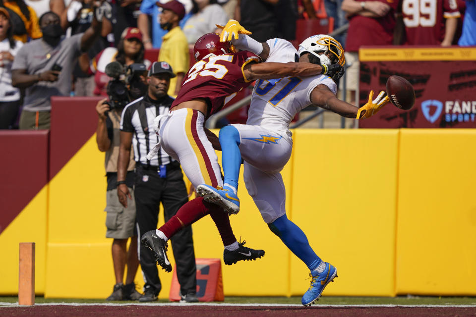 Washington Football Team cornerback Benjamin St-Juste (25) breaks up pass for Los Angeles Chargers wide receiver Mike Williams (81) during the second half of an NFL football game, Sunday, Sept. 12, 2021, in Landover, Md. (AP Photo/Andrew Harnik)