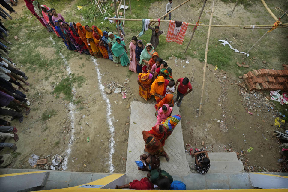 Women stand in a queue to cast their votes during the fourth phase of general election, on the outskirts of Samastipur, in the Indian state of Bihar, Monday, May 13, 2024. Millions of Indians are voting to elect members to the lower house of Parliament during the staggered election, which runs until June 1. (AP Photo/Manish Swarup)