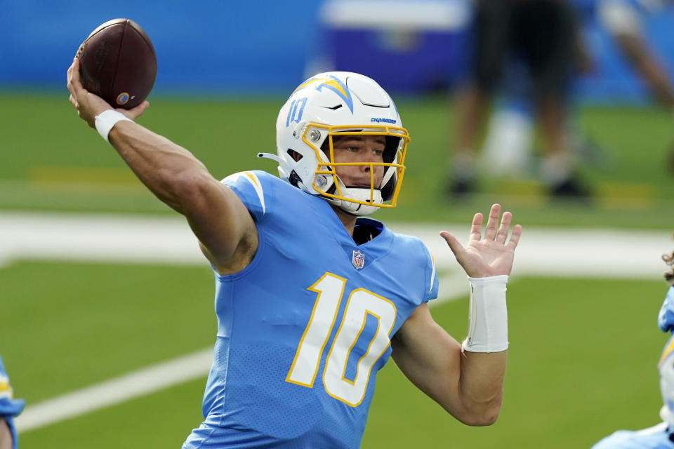 FILE - In this Sunday, Nov. 22, 2020, file photo, Los Angeles Chargers quarterback Justin Herbert throws a pass against the New York Jets during the first half of an NFL football game in Inglewood, Calif. Buffalo's Josh Allen and the AFC East-leading Bills prepare to host the rookie Justin Herbert-led Chargers on Sunday in a showdown of the NFL’s two leaders in yards passing. (AP Photo/Jae C. Hong, File)