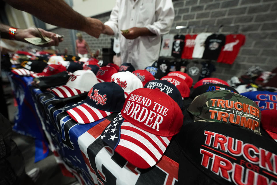 A vendor sells merchandise before Republican presidential candidate former President Donald Trump speaks at his birthday celebration, hosted by Club 47, in West Palm Beach, Fla., Friday, June 14, 2024. (AP Photo/Gerald Herbert)