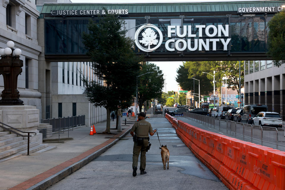 A K-9 officer secures the area around the Fulton County Courthouse in Atlanta on Tuesday. 