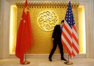 A staff member sets up Chinese and U.S. flags for a meeting during a visit by U.S. Secretary of Transportation Elaine Chao at China's Ministry of Transport in Beijing