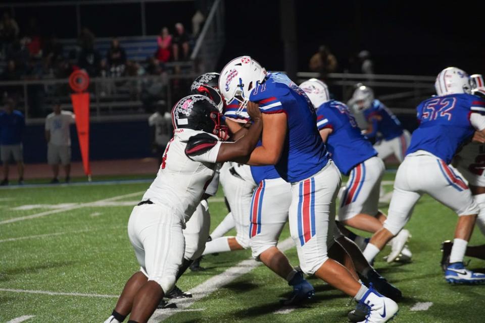 Marion Harding's Mike Williams, left, takes on the block of lineman Bryan Mullins of Highland during a game this season. Williams was a first-team All-Central District pick as a defensive line in Division II by the OPSWA on Monday.