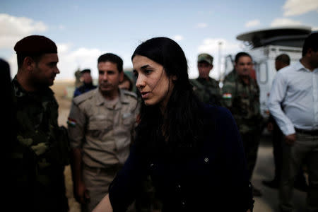 Yazidi survivor and United Nations Goodwill Ambassador for the Dignity of Survivors of Human trafficking, Nadia Murad, greets Kurdish Peshmerga fighters at a defensive point near Sinjar, Iraq June 1, 2017. REUTERS/Alkis Konstantinidis