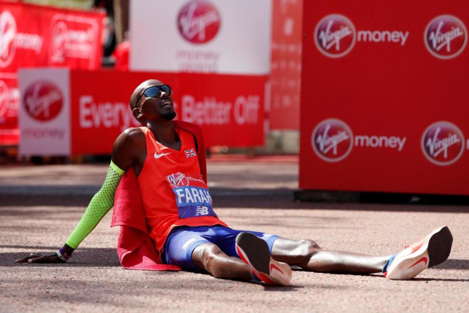 Mo Farah sits on the ground after finishing the London Marathon in third place (REUTERS)